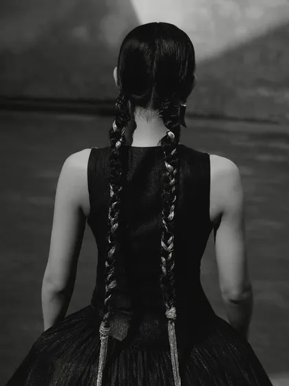 A black and white shot from the Ani Clothing campaign, focusing on the intricate braided hairstyle.