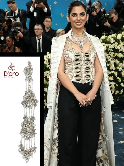 Recreating Isha Ambani's layered Met Gala look. Our dramatic, multi-tiered silver and pearl earrings would be the perfect statement accessory to match her contemporary Indian outfit.