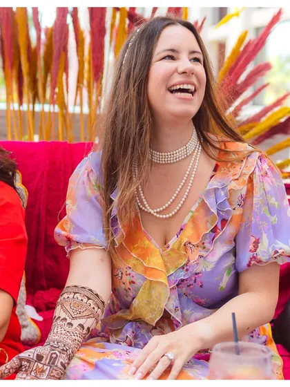 A bride's radiant smile during her Mehendi ceremony, a moment of pure joy as she embraces a beautiful tradition.