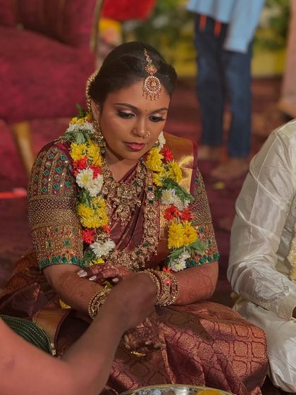 A candid shot of my bride Prithivi during her wedding rituals in Trichy. Her makeup is designed to be long-lasting and photo-ready, even during the most emotional moments of the ceremony.