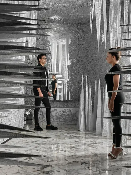 The use of mirrors within the 'Palate Cleanser' installation creates an infinite, repeating reflection of the sculptural forms and the people within. This visual trick enhances the feeling of being in a completely different, almost surreal, dimension.