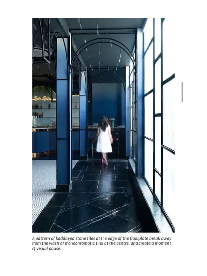 A pattern of Kadappa stone tiles at the edge of the floorplate creates a moment of visual pause. This detail, highlighted in the AD feature, shows our attention to material and composition.