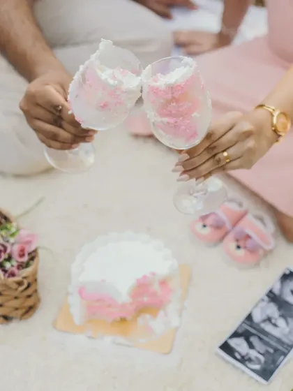 A close-up of the celebration. The "It's a girl" themed cake, baby shoes, and sonogram picture make for a perfect and detailed announcement shot.