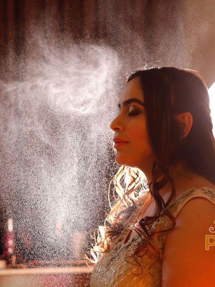 A magical shot of the setting spray in action. This is a crucial final step to ensure the makeup stays flawless and lasts all day and night.