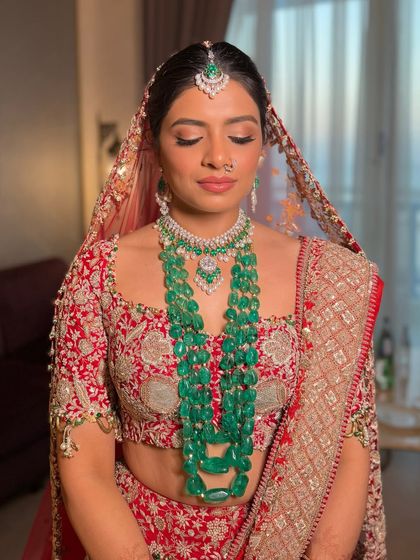 A serene moment showing the bride with her eyes closed. This highlights the soft, blended eyeshadow and the flawless base that creates a perfect canvas, ensuring the makeup looks beautiful even in quiet, reflective moments.