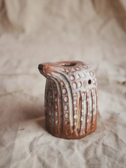Each dot on this pajarito was individually pressed into the clay, creating a pattern that is both visual and tactile.
