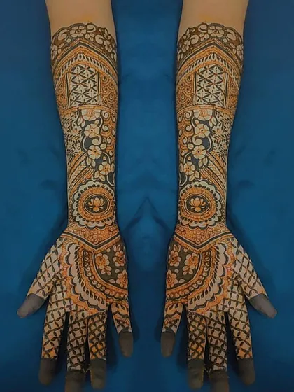 A symmetrical bridal design that extends up both forearms. I used a mix of geometric grids, mandalas, and floral elements to create this detailed and balanced artwork.