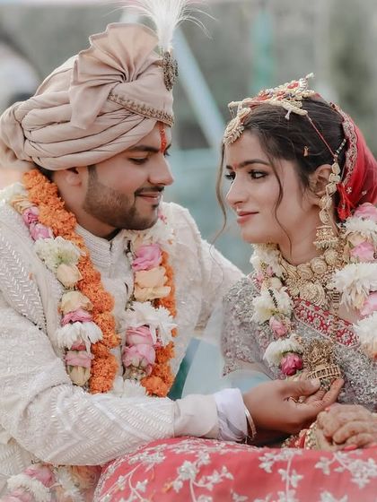 A candid moment between the couple during their wedding ceremony, sharing a look and a smile.