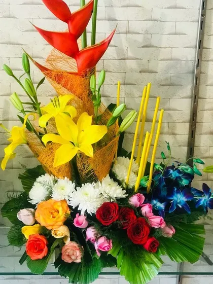 If you want a custom design, I can create it for you. This is a unique, artistic arrangement with mixed flowers like heliconia, lilies, roses, and orchids for a truly special occasion.