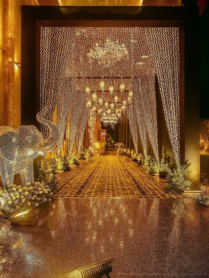 The first impression is everything. We design entrances that build anticipation and set the mood, like this magical, glittering tunnel of light that welcomes guests into a world of celebration and luxury.