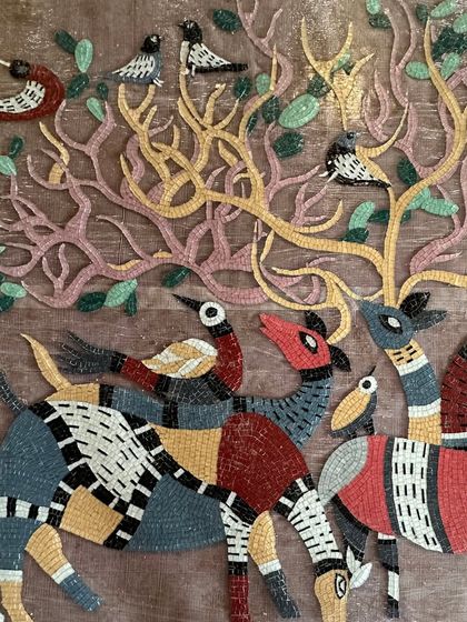 Another detail of the mosaic, highlighting the intricate patterns on the deer and the birds perched in the trees.