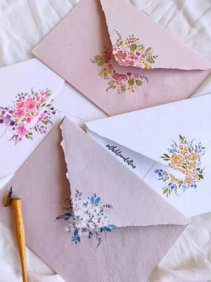 A collection of the hand-painted envelopes for my gratitude letters, each one a small canvas for my floral art.