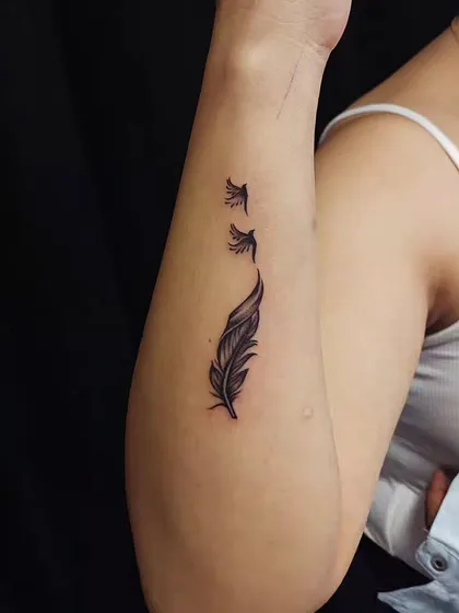 A feather transforming into a flock of birds. This popular design is a beautiful metaphor for freedom, letting go, and transformation.