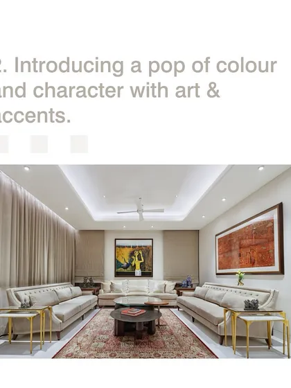 Introducing a pop of color and character with art and accents can personalize a space. In this formal living room, large paintings add personality to an otherwise neutral and calming palette.