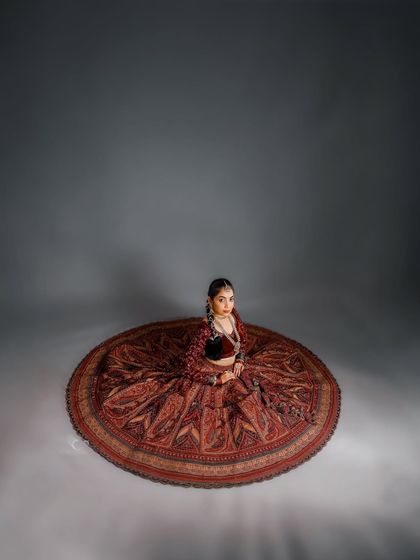 Another perspective of the lehenga spread like a mandala. This high-angle shot in the studio emphasizes symmetry, artistry, and the subject as the center of her own universe.