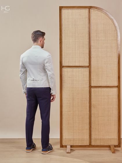 A back view of the complete outfit, showing how the crisp white shacket pairs with navy trousers for a timeless and sophisticated color combination.