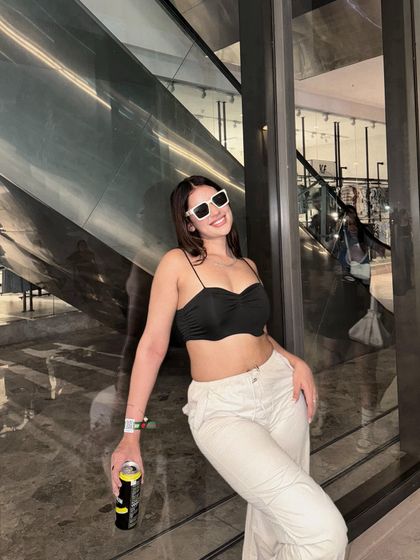 A smiling shot in the casual concert-ready outfit.