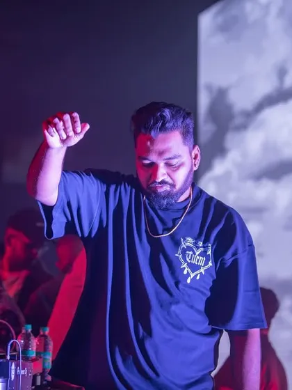 A moment of reflection during a set, with a cool cloud projection in the background. The visuals add another layer to the music.