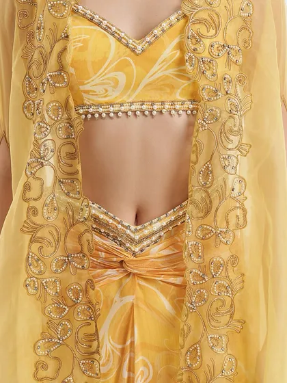 A close-up of the Rumi Cape Set, showcasing the eccentric elements of cutwork and ornamentation on the organza cape.