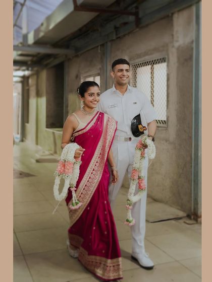 A happy portrait of the bride in her pink saree and the groom in his Navy uniform. This shot beautifully captures their joy and the unique story of their court wedding.