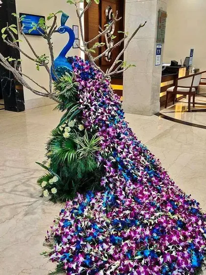 This is an example of my detailed floral artistry. I constructed this life-sized peacock using hundreds of fresh purple and blue orchids, creating a stunning statement piece for a luxury hotel lobby or a grand wedding entrance.