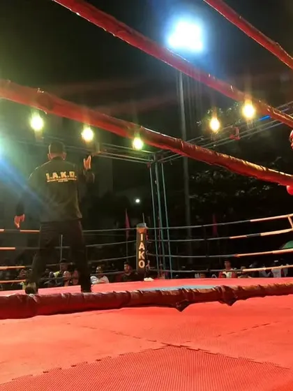 The fighters reset in the center of the ring, ready for the next engagement.