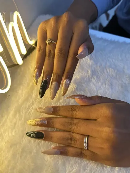 These stiletto nails are pure glamour. I combined nude and black polishes with gold glitter for a client's special birthday look.