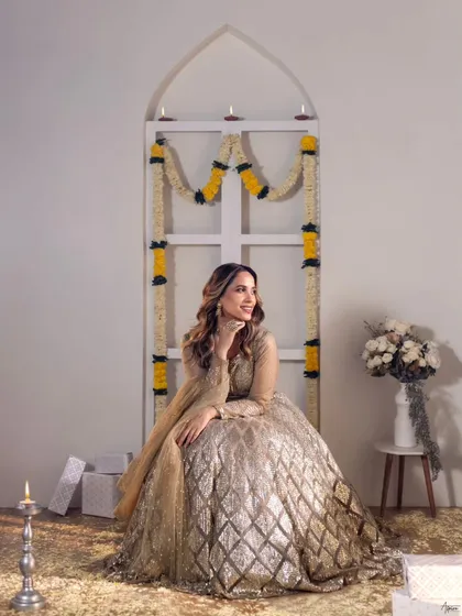 Another joyful expression from our festive series. This image highlights the intricate details of the sparkling lehenga and the warm, inviting ambiance we created in the studio.