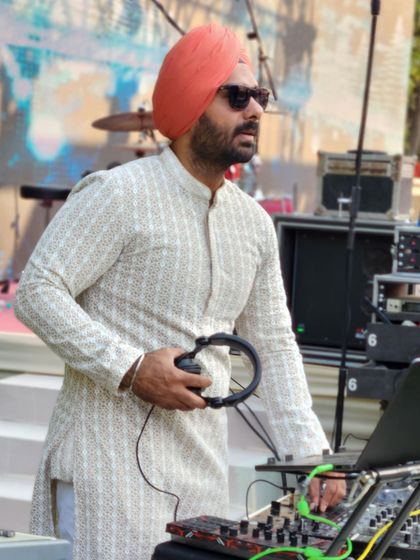 Taking a moment between tracks, always focused on what the crowd needs next.