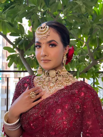 A close-up of my gorgeous bride in her deep red reception saree. The makeup features a dramatic eye and a complementary lip color.