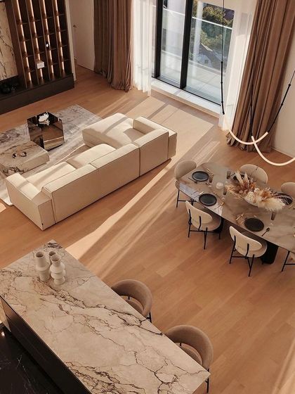 An overhead view of a luxurious open-plan home, showing how the Leda fixture provides a soft, curving line of light that complements the modern, clean-lined interior design.