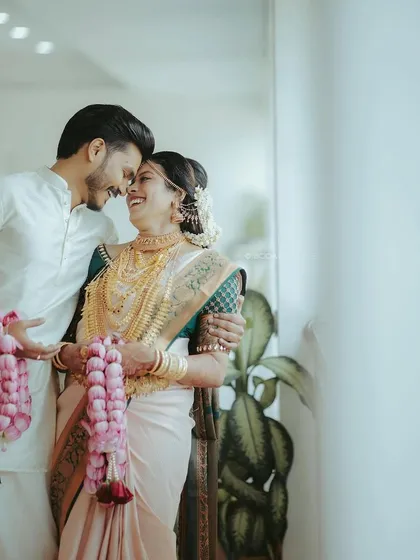A romantic shot of the happy couple. The groom's simple and elegant white kurta look was perfect for their traditional wedding.