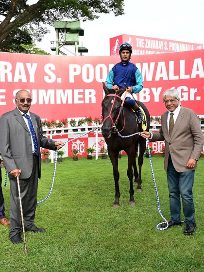 Emphatic, winner of The Chennai Cup, is pictured with jockey P. Trevor and the owners.