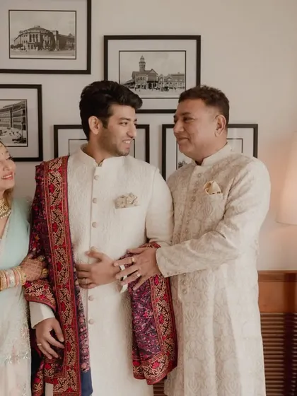 The groom sharing a special moment with his parents before the wedding ceremony begins.