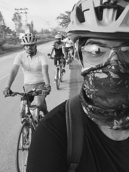 A black and white selfie taken while riding, capturing the focus and determination of the group.