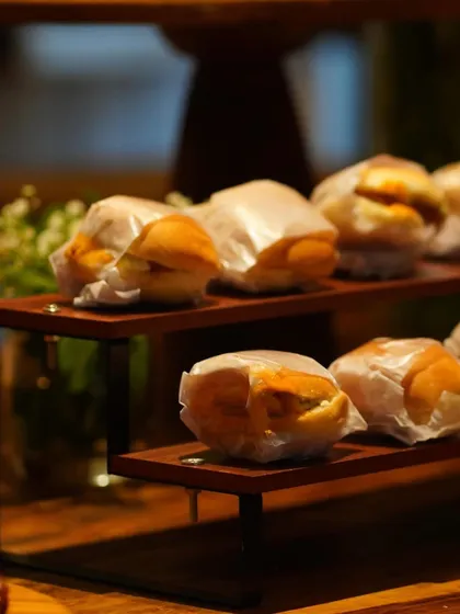 A close-up of our mini vada pavs, individually wrapped for easy serving. These bite-sized treats are a huge hit at house parties and casual get-togethers.
