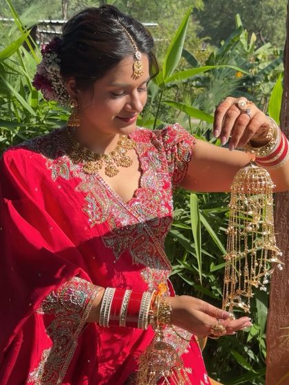 Yogita admiring her kalire. This candid shot showcases her glowing skin and the subtle makeup that enhances her happiness without feeling heavy or overdone.