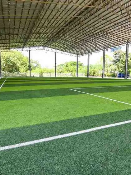 We build professional-grade, all-weather football arenas. This covered facility showcases a large-scale installation that allows for year-round play, protected from rain or harsh sun, with a surface designed for peak performance.