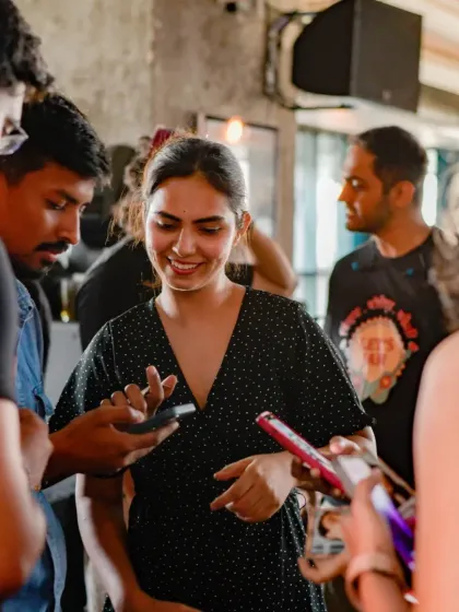 A group of people exchanging numbers and connecting after a jam. This is what community building looks like.