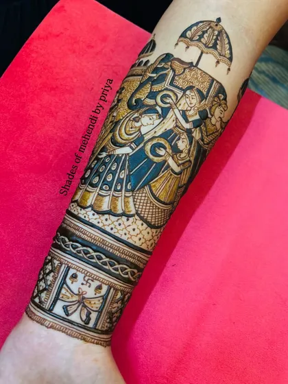 A view of the lower part of the arm, showing how the intricate patterns connect the larger storytelling elements of the bridal design.