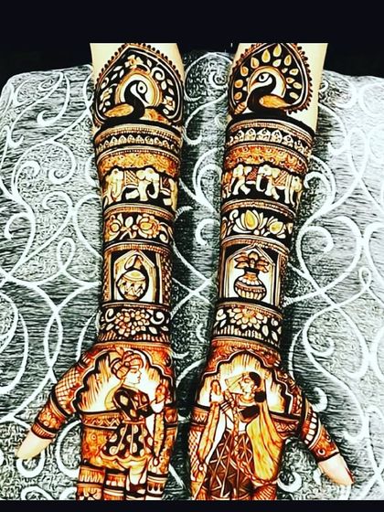 A stunning full-coverage design featuring peacocks, elephants, and bride-groom figures. This is a popular choice for a grand bridal look.