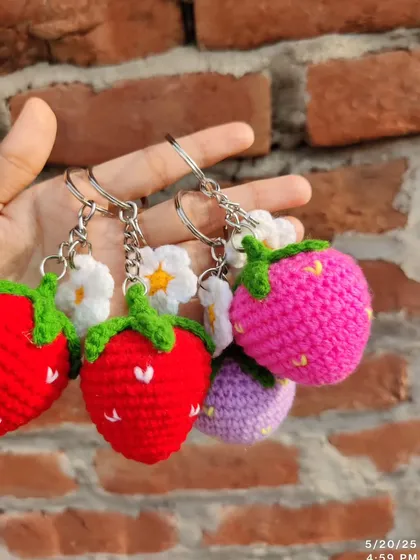 Sweet strawberry and daisy keychains. These come in red, pink, and purple, each with a little white flower.
