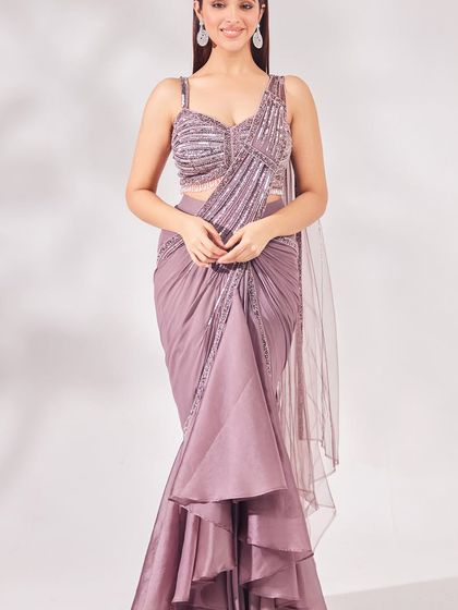 Modern elegance in mauve. This fish-cut, pre-draped saree with a sequined blouse is a sophisticated and contemporary choice for a cocktail party or reception.