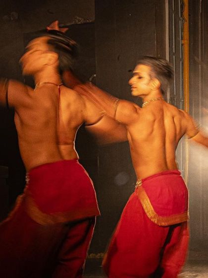 A motion-blur shot from 'PADAM', capturing the speed and energy of the duet.