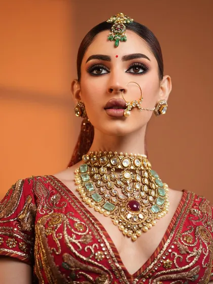 A powerful, direct gaze from this stunning bride, her makeup bold and flawless.