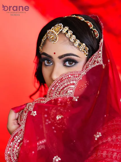 The classic veil shot, adding an element of mystery and tradition while highlighting the intense eye makeup.