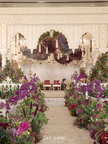 The view from the aisle of the "Garden of Vows" mandap. I used a rich palette of purples, reds, and pinks to create a vibrant and passionate atmosphere, with floral clouds floating above the ceremony space.