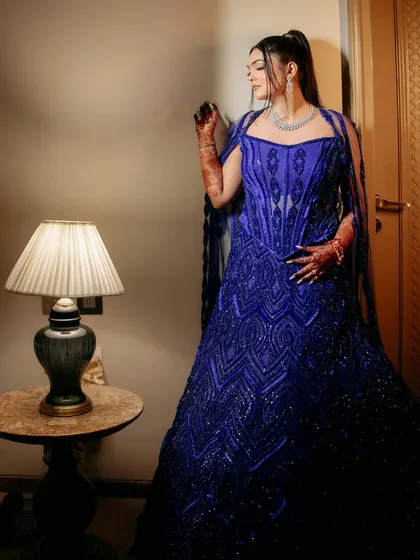 A client looking splendid in an active blue, fully embellished corset lehenga with a gracefully draped dupatta on the shoulder.