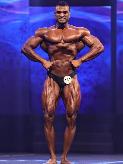 This is the Front Lat Spread in peak condition on stage. Notice the width from the lats and the tight midsection. I teach the technicalities of this pose in my professional posing series on YouTube.