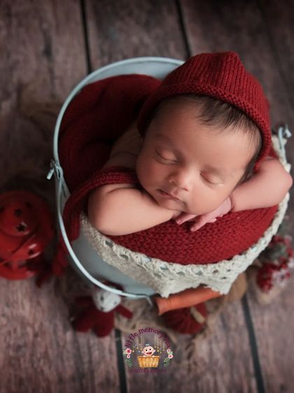 This pose, with baby's head resting gently on their hands in a bucket, is a classic for a reason. It shows off their tiny profile and peaceful expression in such an adorable way.